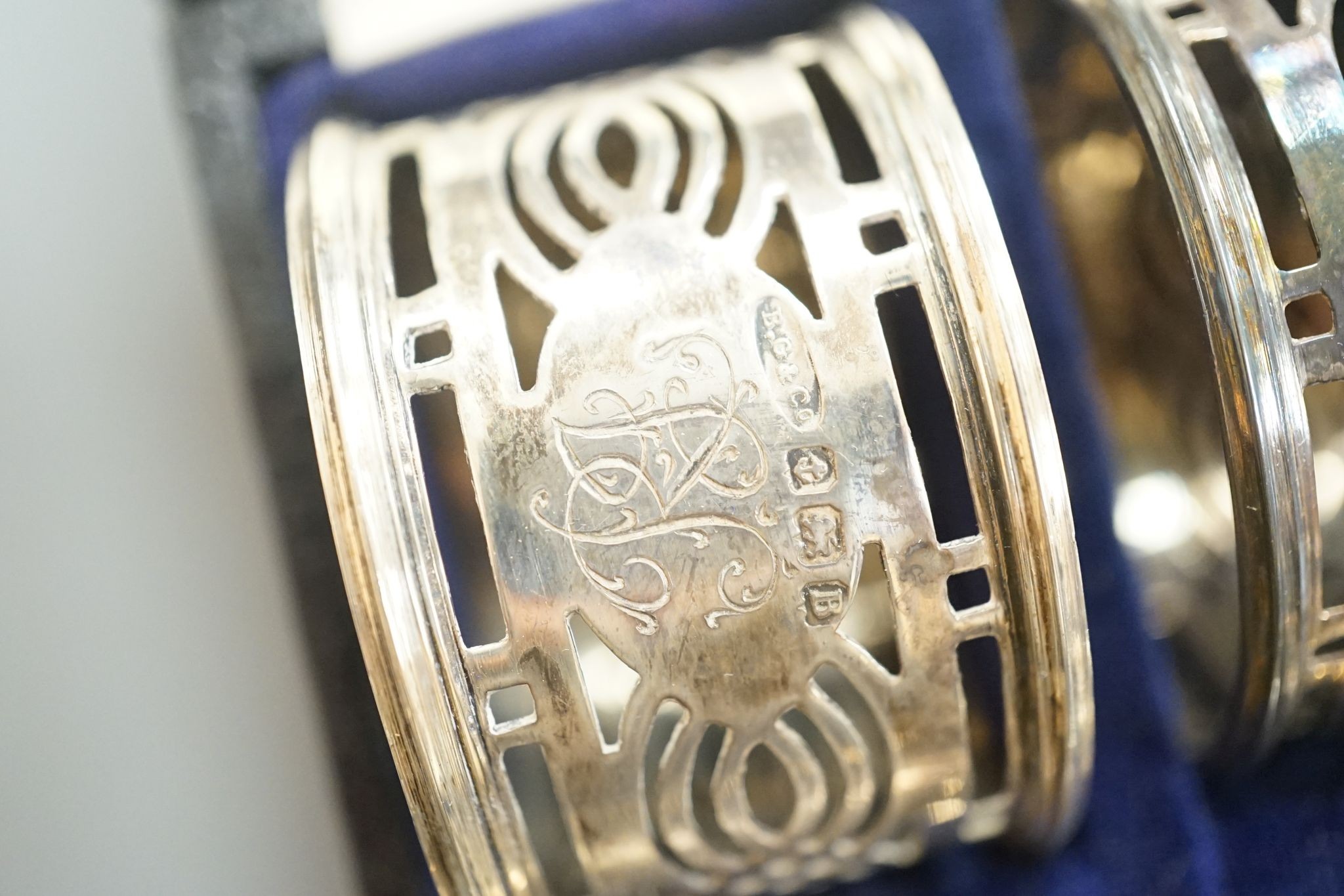 A cased set of six George V pierced silver napkin rings, Birmingham, 1926.